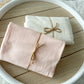 Stretchy fabric wraps for newborn photography in two color options: ivory or blush
