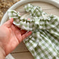 The back of the green and ivory romper with ruffles on the back, perfect as newborn photography prop