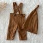 Newborn photo prop set in chestnut brown, including stretchy pants with sewn-in suspenders and cozy sleepy hat.