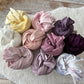A selection of 10 colors of newborn wraps for newborn photography from pastels to rich dark colors