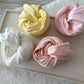 Newborn fabric wraps, stretchy and soft cotton for newborn photography in: ivory, light yellow, light pink, and peach.