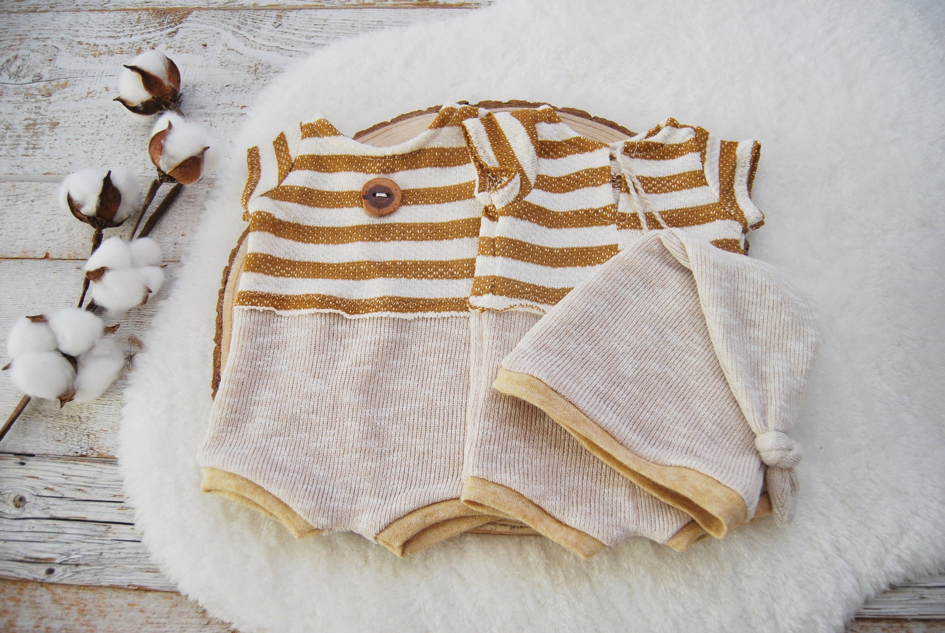 The set includes a newborn romper and a sleepy hat, both made with soft and stretchy knit fabrics. The romper features short sleeves and no legs. The top part has striped pattern in mustard and beige, while the bottom part is plain beige color.