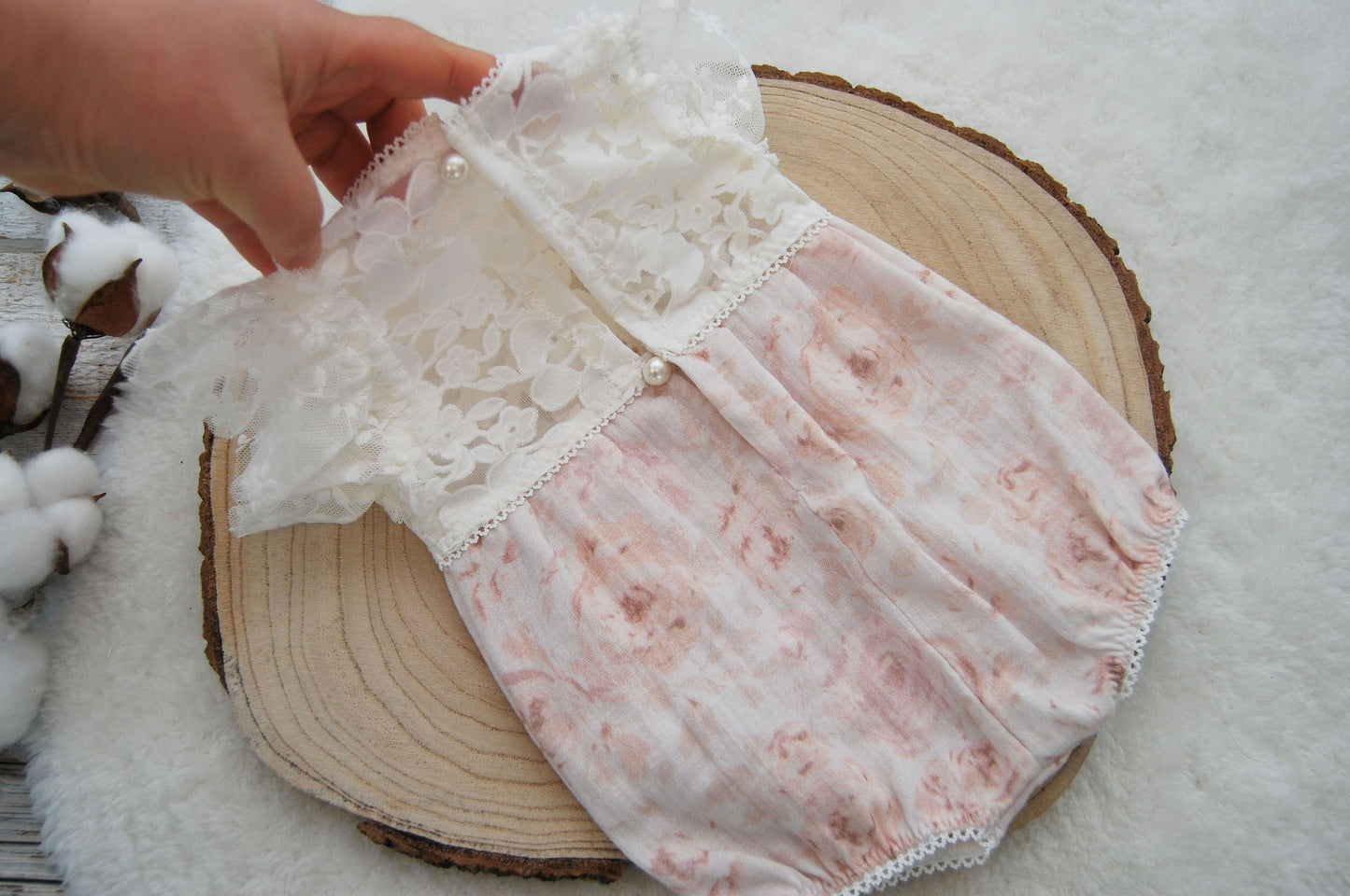 Newborn romper photo prop, light pink and white. The top part is made of dainty lace with floral texture in off white color, while the bottom part is soft muslin with light roses print on white background.