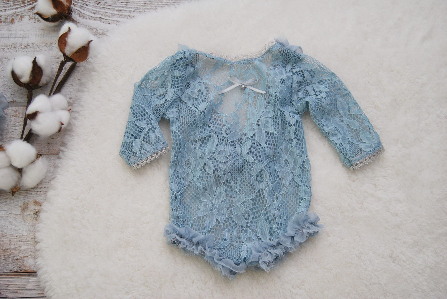 Soft and stretchy newborn girl outfit for photography shoots. In a beautiful powder blue color with soft ruffles on the back and on the leg openings.