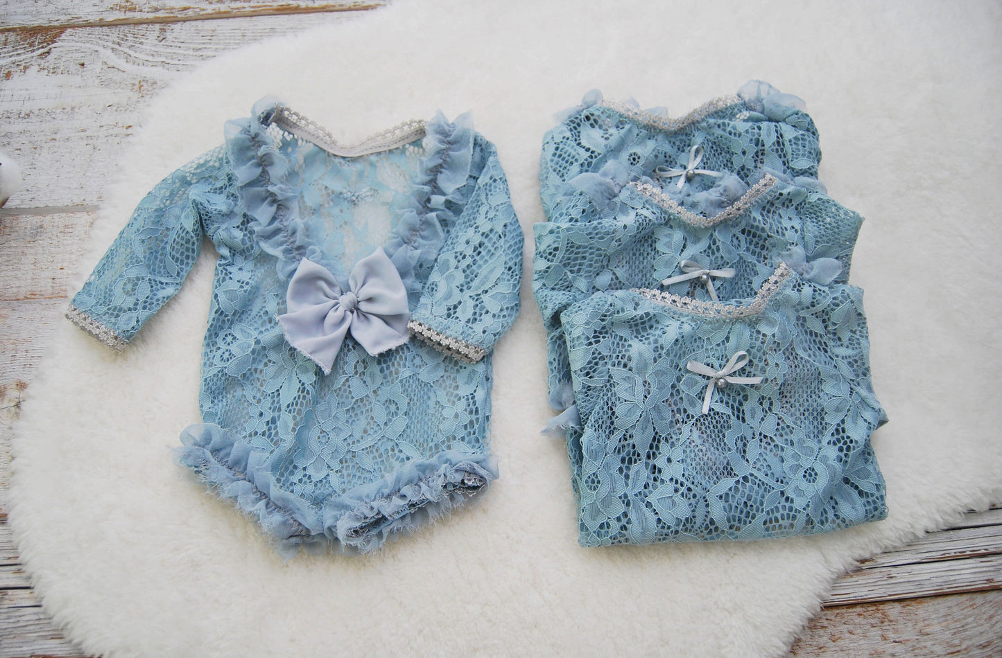 Newborn ruffled lace romper for baby girls, in light blue color.